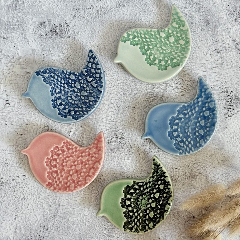 Set of five bird-shaped ceramic dishes with lace texture in blue, green and pink glazes